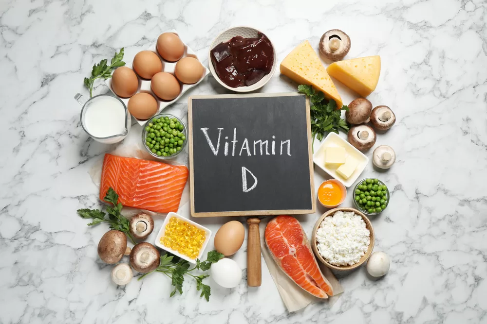 Food sources of vitamin D around chalkboard with vitamin D written on it